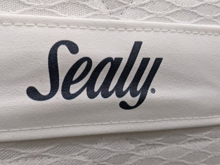 Sealy logo on side of bed